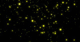 Image of glowing yellow spots falling on black background