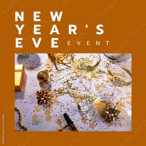 Composition of new year's eve celebration text over party table with glasses