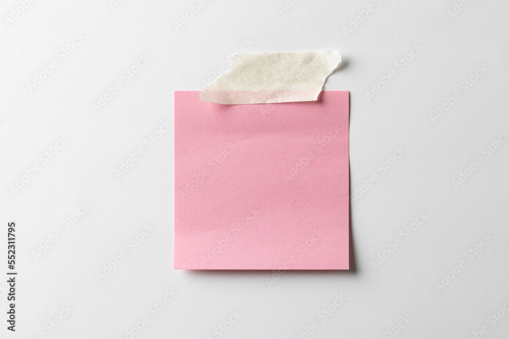 Pink sticky memo note with tape and copy space on white background Pink sticky memo note with tape and copy space on white background