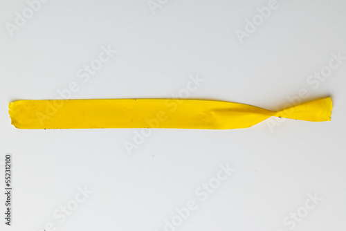 Ripped up piece of yellow tape with copy space on white background