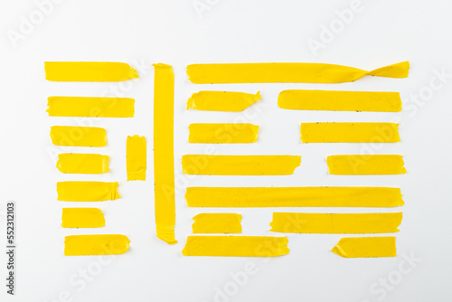 Ripped up pieces of yellow tape with copy space on white background