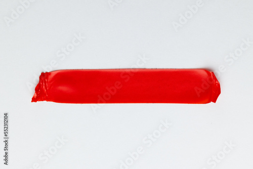 Ripped up piece of red tape with copy space on white background