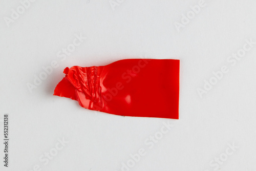 Ripped up piece of red tape with copy space on white background
