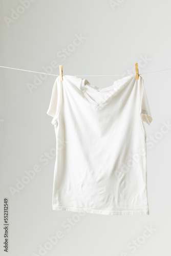 Close up of hanging white tshirt and copy space on white background