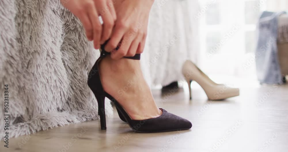 Video of biracial woman putting black high heels on Video of biracial woman putting black high heels on