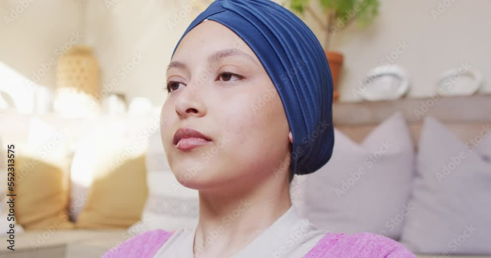 Video of tranquil biracial woman in hijab doing yoga meditation, closing eyes and deep breathing Video of tranquil biracial woman in hijab doing yoga meditation, closing eyes and deep breathing