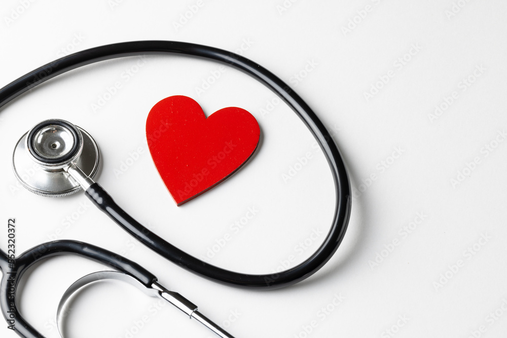 Composition of stethoscope and red heart on white background with copy space Composition of stethoscope and red heart on white background with copy space