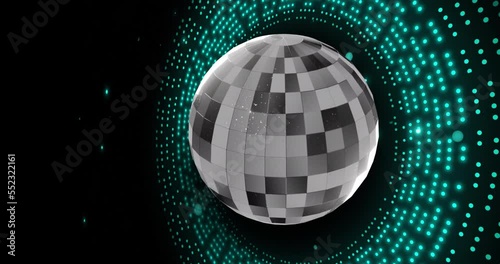 Animation of retro disco mirror ball and glowing blue light on black background photo