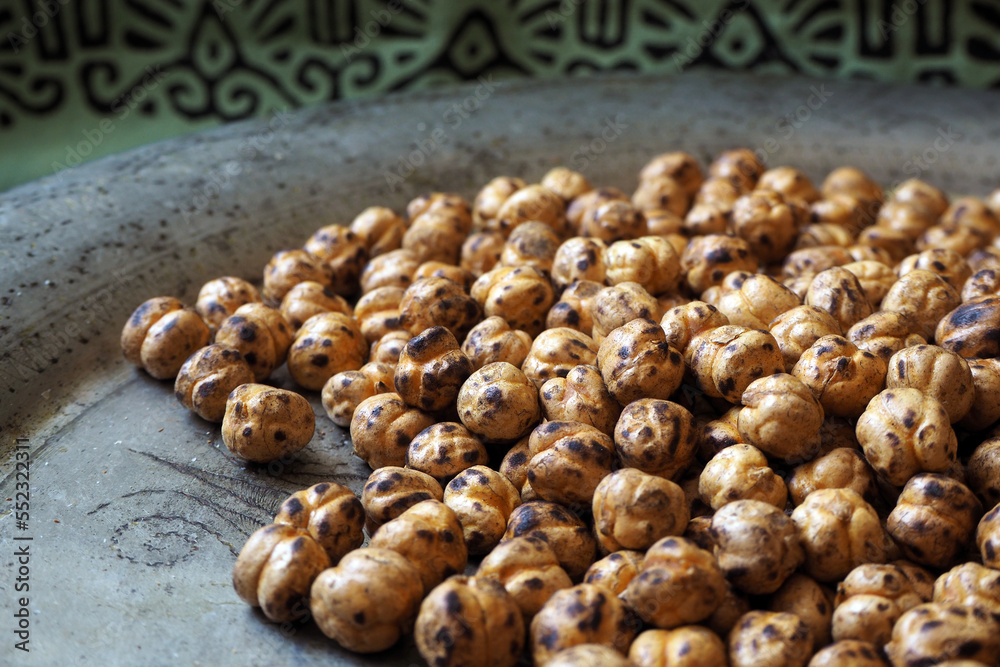 Leblebi, traditional Turkish nuts (roasted chickpea) on local motifs. Leblebi, traditional Turkish nuts (roasted chickpea) on local motifs.