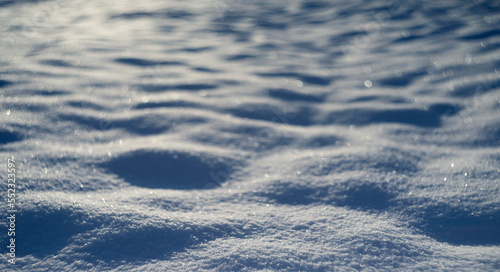winter snow background - snow covered surface and artistic bokeh