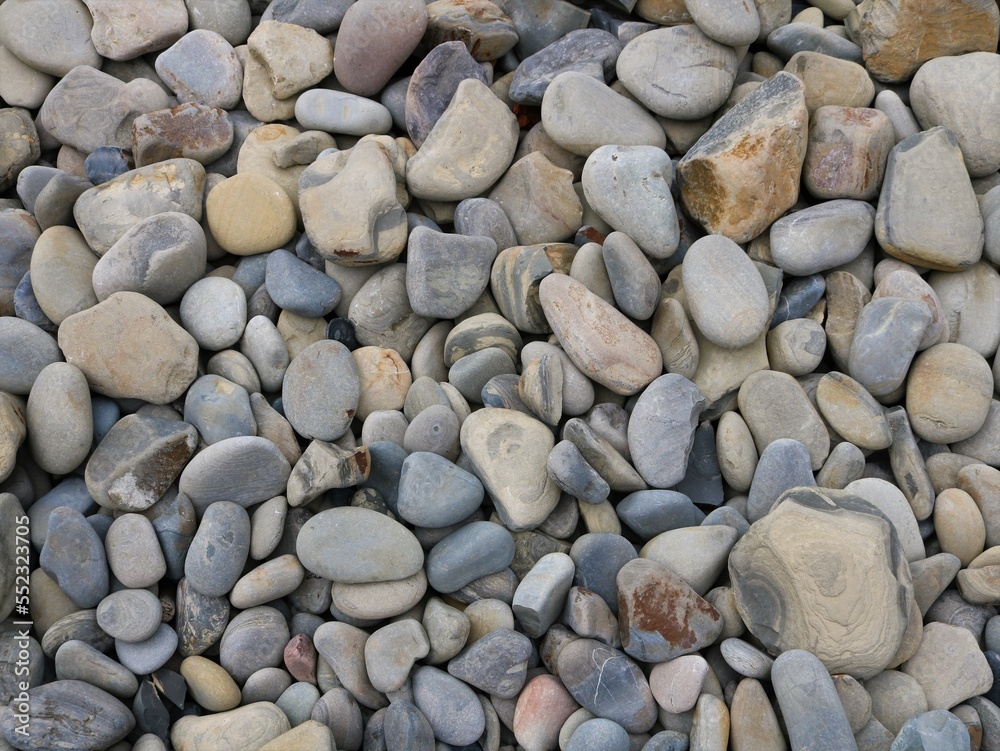 stone background of round cobblestones of different shades of gray and brown, natural texture of rounded river or sea stones full frame, stones and minerals on the coast of the sea or river stone background of round cobblestones of different shades of gray and brown, natural texture of rounded river or sea stones full frame, stones and minerals on the coast of the sea or river
