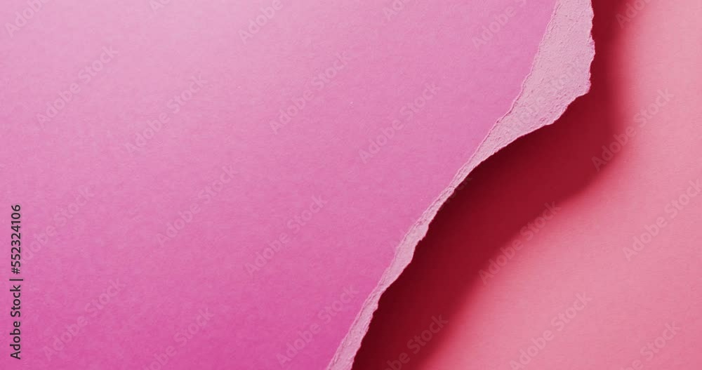 Video of close up of torn pieces of pink paper with copy space in background