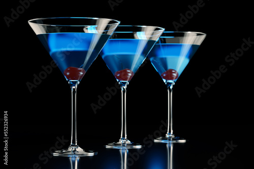 Three blue cocktails with cherry on black background