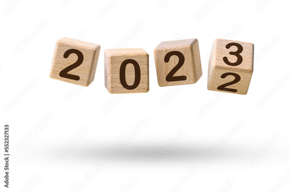 Happy new year concept. Wooden cube blocks changing from New year 2022 to 2023 flying over white Happy new year concept. Wooden cube blocks changing from New year 2022 to 2023 flying over white