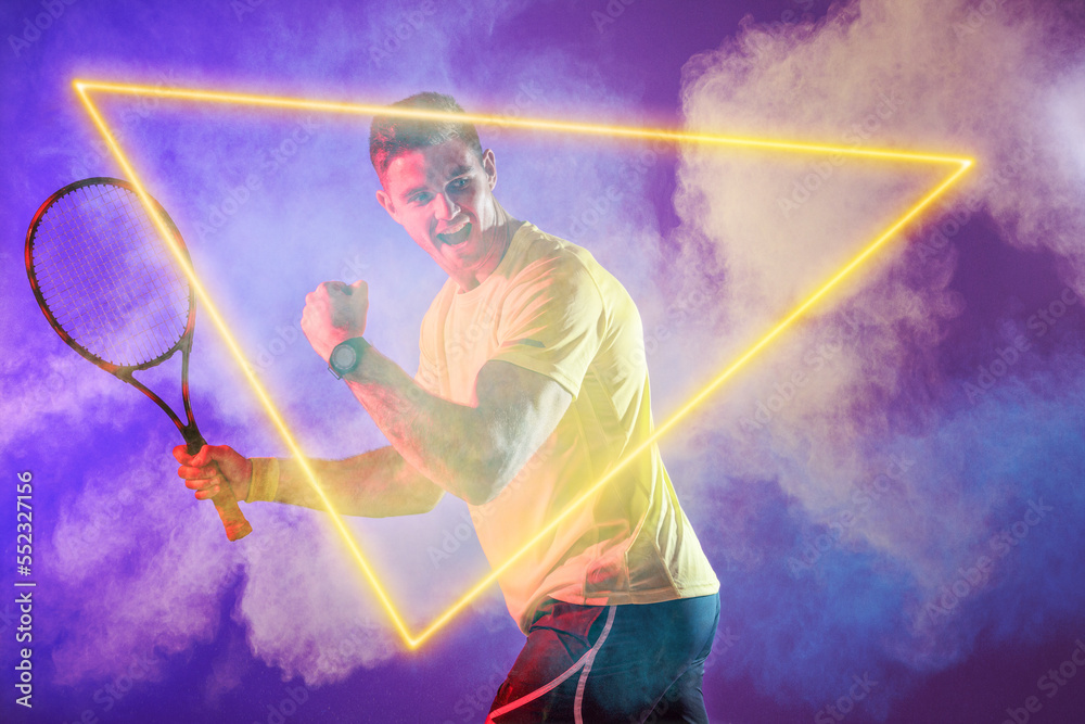Caucasian male tennis player holding racket and screaming by illuminated triangle, copy space