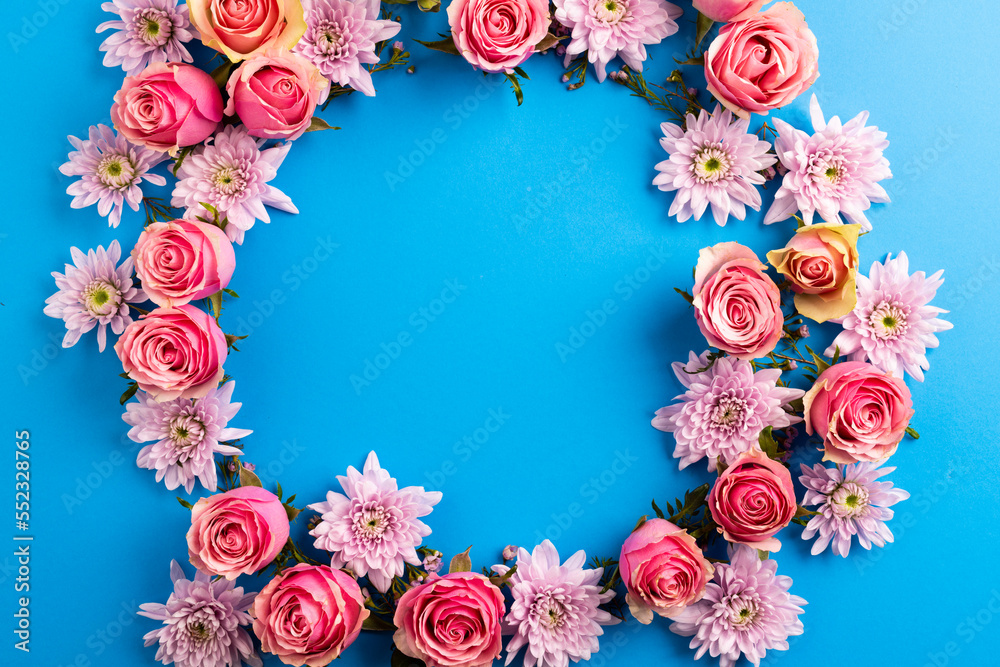 Composition of rose wreath on blue background Composition of rose wreath on blue background