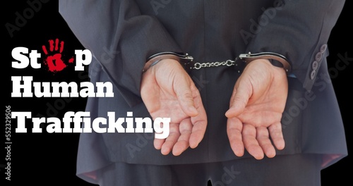 Composite of rear view of caucasian businessman with handcuffs and stop human trafficking text