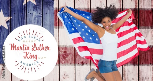 Foto Portrait of happy young african american woman holding usa flag jumping by marti