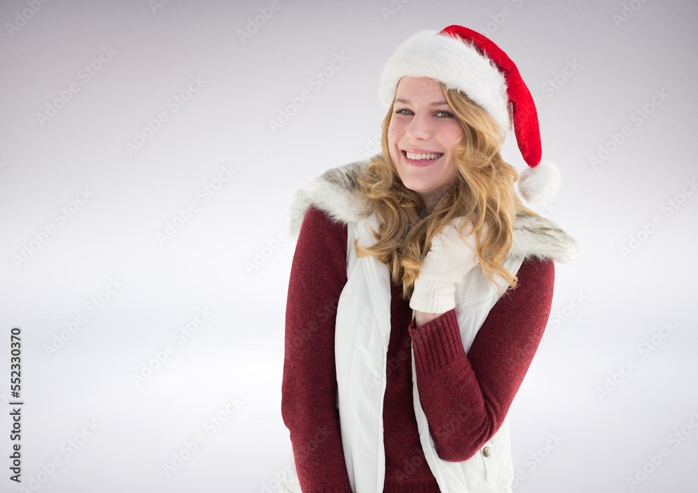 Portrait of caucasian woman wearing santa hat smiling against copy space on grey background Portrait of caucasian woman wearing santa hat smiling against copy space on grey background