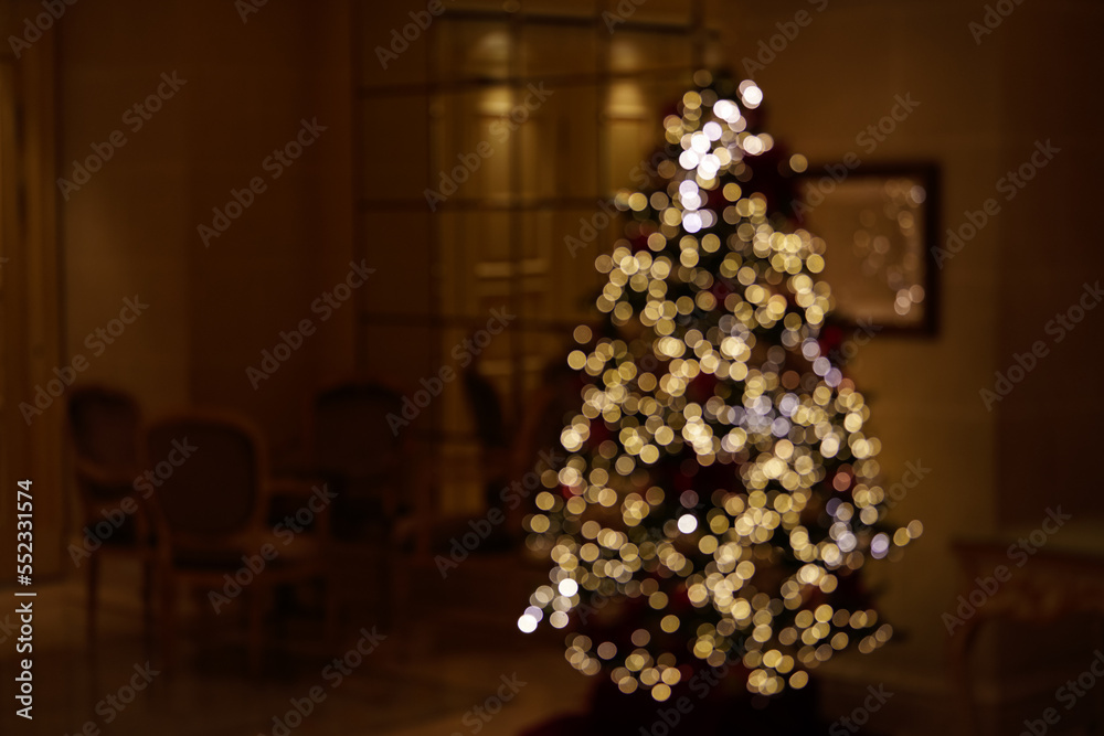 Blurred photo with the led light installation on a Christmas tree in background. Concept image for the winter holidays.