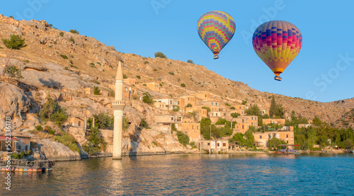 Hot air balloon flying over Historical Halfeti town and mosque along Euphrates River - Gaziantep,Turkey