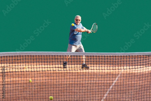 Active senior enjoys sports while playing tennis. Elderly tennis player playing ball on red clay court. Vitality, sports activity, healthy lifestyle in old age, aging youthfully concept photo