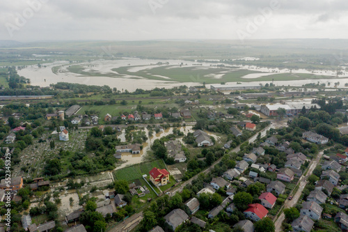 Climate change and the effects of global warming. Flooded village, farms and fields after heavy rains. Environmental natural disaster. Concept of global catastrophes in the world photo