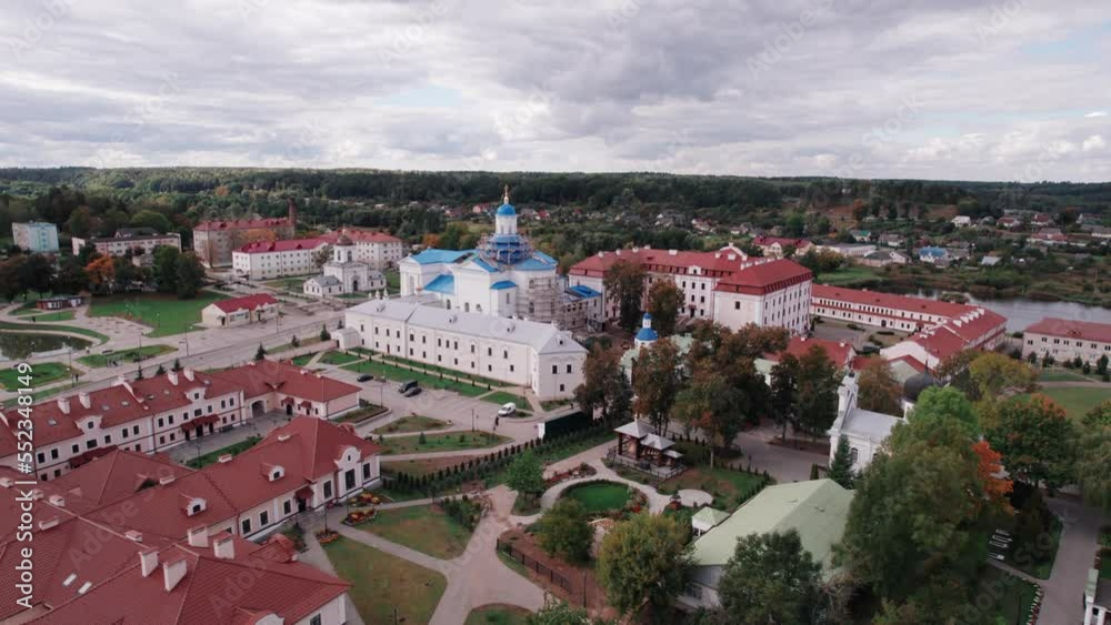 Aerial view of an orthodox church under construction surrounded by complex of buildings on the outskirts of the town