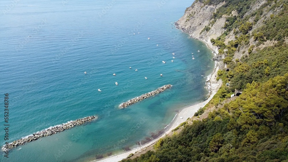 Liguria, Cinque Terre , drone aerial view of Framura a sea village with amazing blue sea and beach - Summer holidays in North Italy - beautiful natural bay with crystal clear sea in the Mediterranean