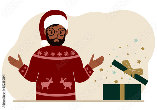 A man near an open Christmas or New Year's gift. Gift box for winter holidays.