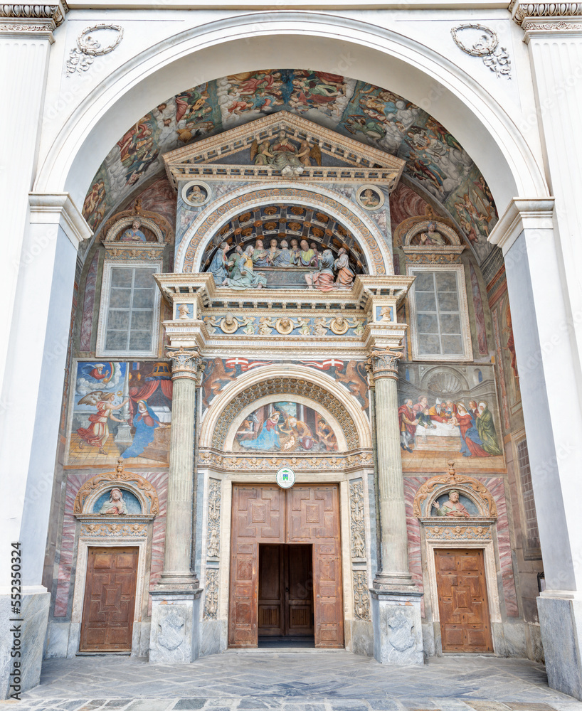 AOSTA, ITALY - JULY 14, 2018: The facade of Cathedral - Cattedrale di Santa Maria Assunta with the frescoes by Ambrogio by Bellazzi da Vigevano from 16. cent.