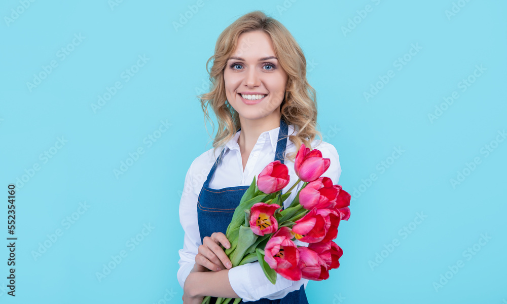 glad flower seller woman in apron with spring tulip flowers on blue background glad flower seller woman in apron with spring tulip flowers on blue background