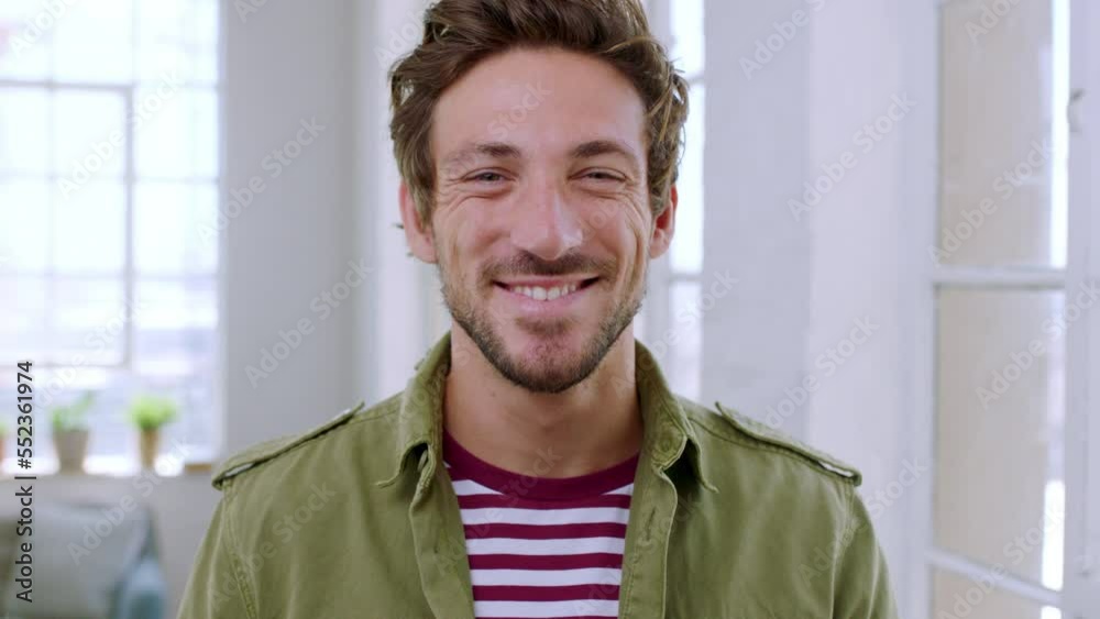Face, happy and mindset with a man in his home, standing by a window with a smile and beard. Portrait, confidence and vision with a handsome young male posing in a modern england house alone Face, happy and mindset with a man in his home, standing by a window with a smile and beard. Portrait, confidence and vision with a handsome young male posing in a modern england house alone