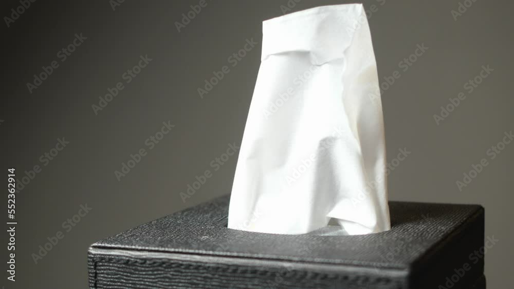  hand pull out a piece of tissue from tissue paper box 