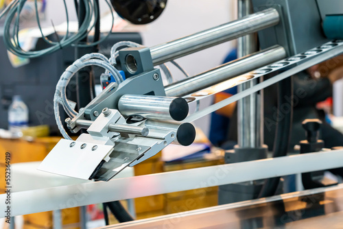 Fotografie Close up automatic continuous labeling machine for labelling product on belt con
