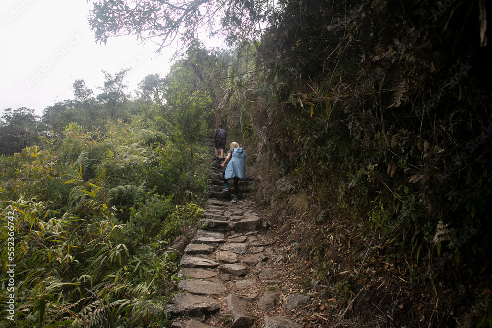 Walking towards the city of Machu Picchu by the Inca trail. Stone staircase.