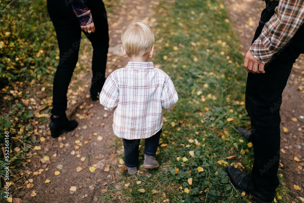 Fototapeta premium happy family playing and laughing in autumn park