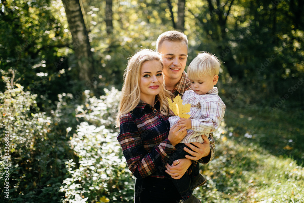 happy family playing and laughing in autumn park
