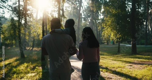 Asian family enjoys walking together in green park