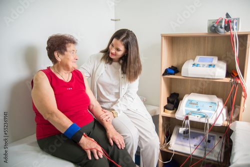Senior old woman on physical therapy in the clinic
