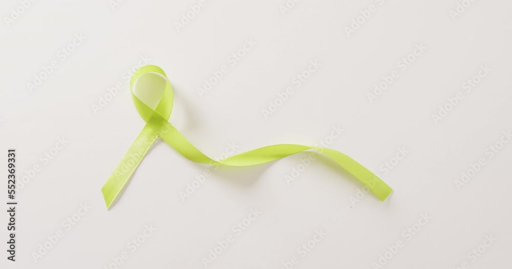 Video of pale green std awareness ribbon on white background with copy space Video of pale green std awareness ribbon on white background with copy space