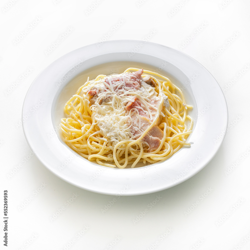 Classic pasta carbonara on whit plate on white background close up isolated on white