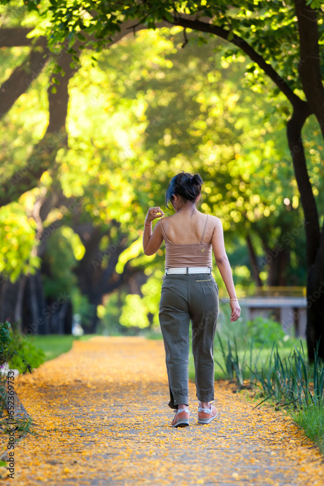 Young woman walking through city streets in autumn or spring Young woman walking through city streets in autumn or spring
