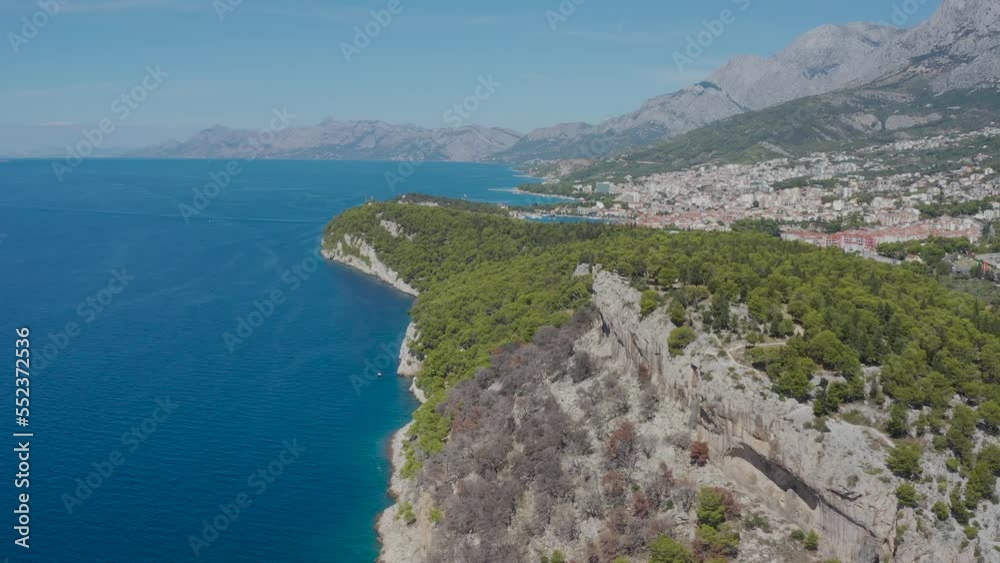 Aerial photography from a drone in flight over the coastal cliffs with a panorama of the city of Makarska. Croatia Aerial photography from a drone in flight over the coastal cliffs with a panorama of the city of Makarska. Croatia