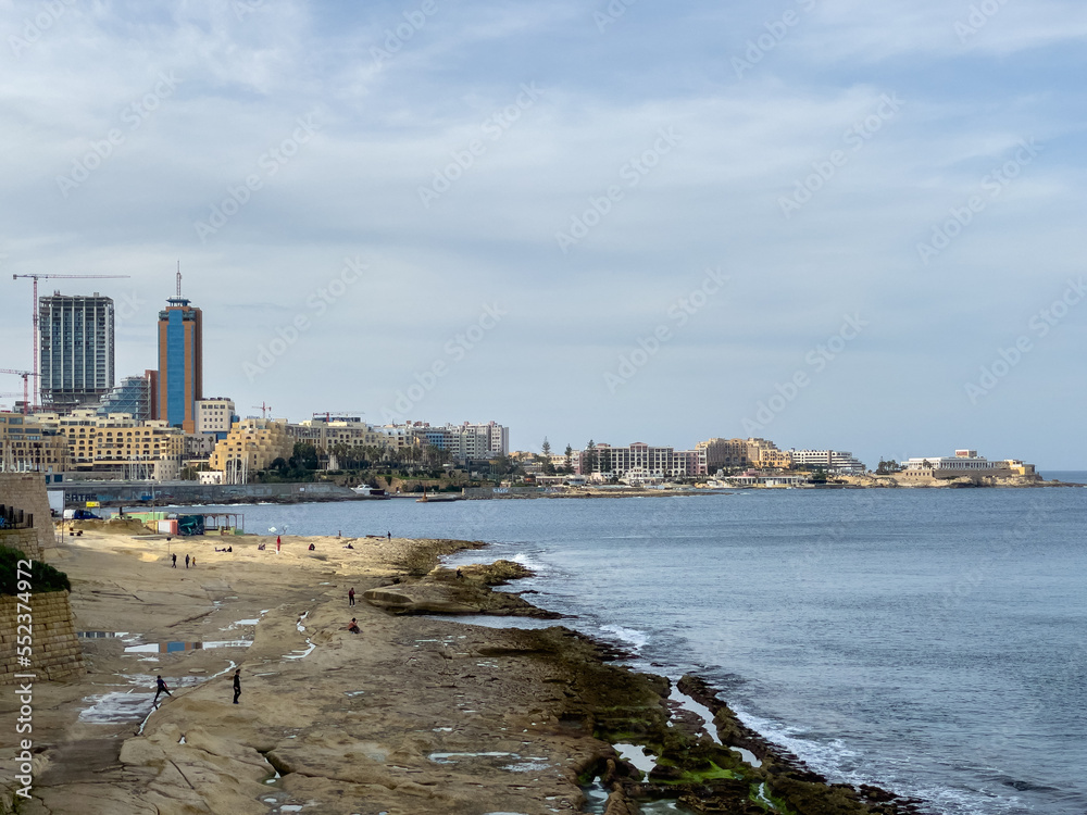 Sliema Beach with the town of St. Julian's in the background.