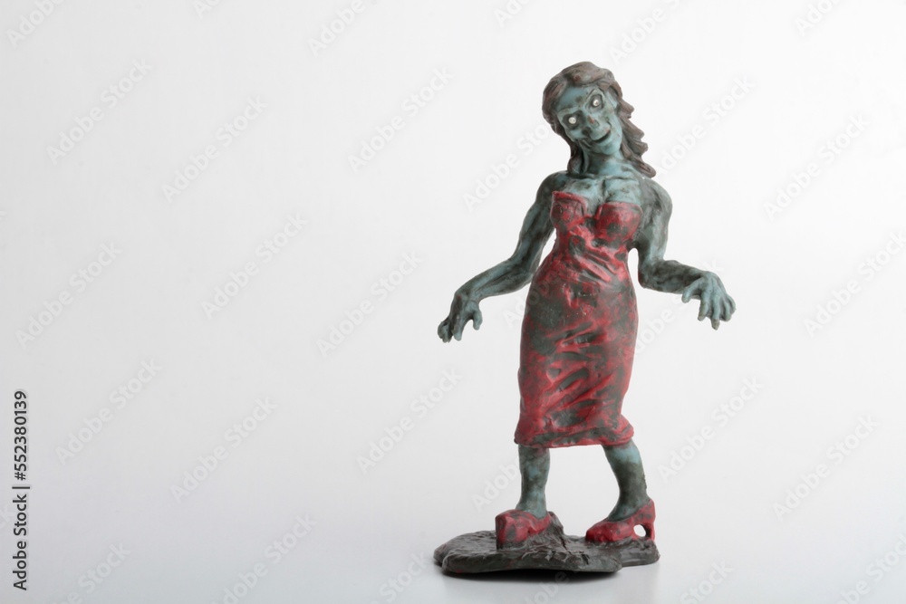 miniature figurine of a zombie doll on a white background miniature figurine of a zombie doll on a white background