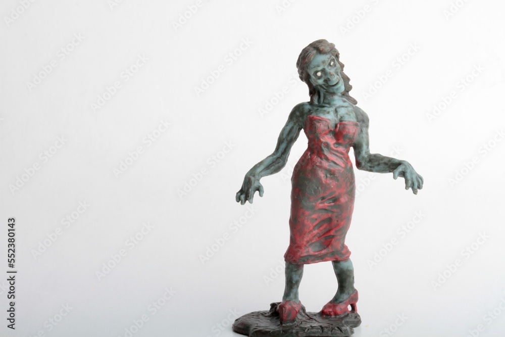 miniature figurine of a zombie doll on a white background miniature figurine of a zombie doll on a white background