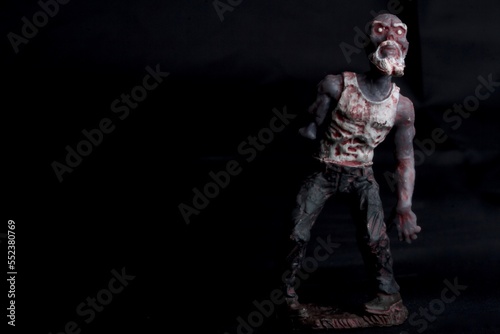Fototapeta Naklejka Na Ścianę i Meble -  close up of a zombie doll against a black background
