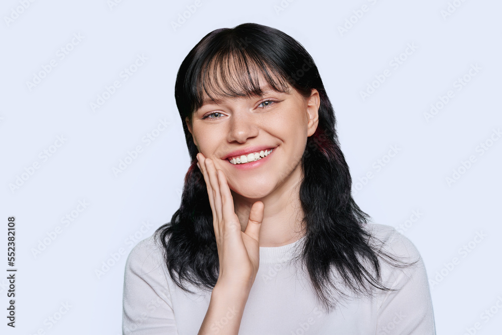Smiling teenage beautiful girl on white studio background Smiling teenage beautiful girl on white studio background