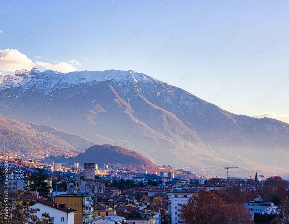 Obraz premium The castle of Trento and the Panarotta mountain with its snowy peak.